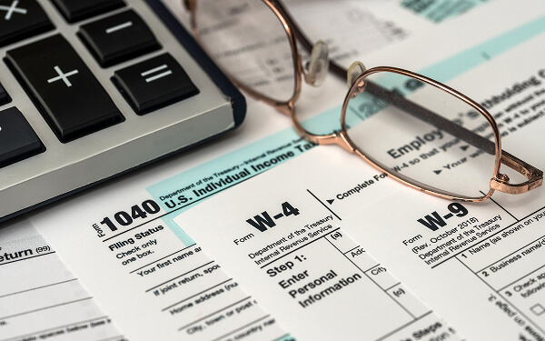 Eye glasses laying on top of tax documents