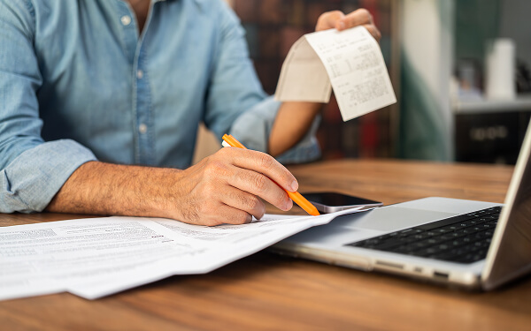 Person tallying up expenses for taxes