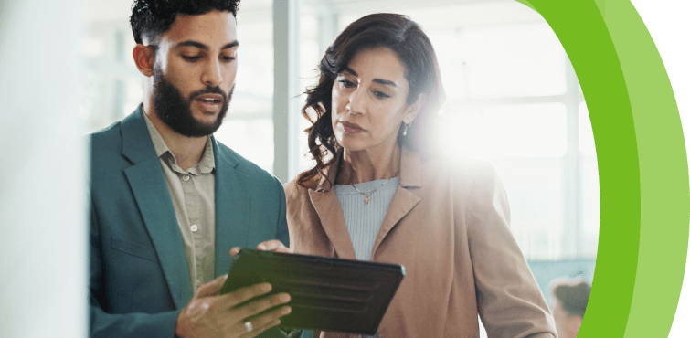 Two people looking at a tablet.
